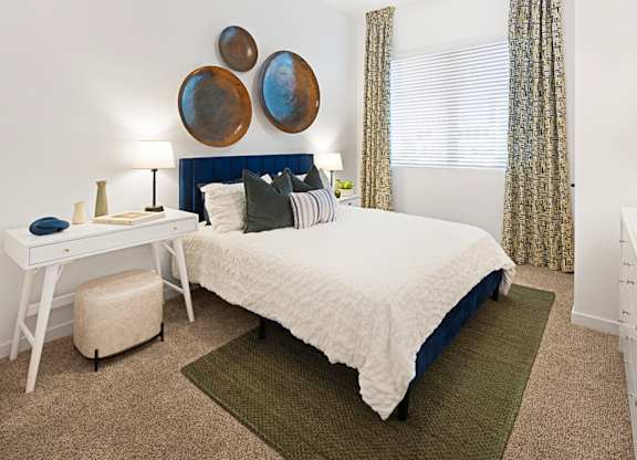 a bedroom with a bed and a desk and a window at Aura Vegas Apartments, Nevada, 89103