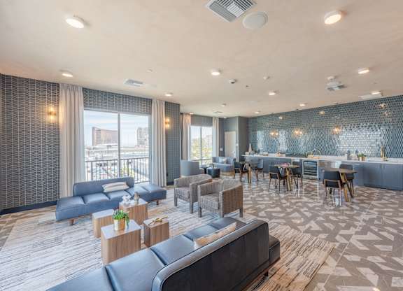 A spacious living room with a dining area and a balcony with a view of the city.