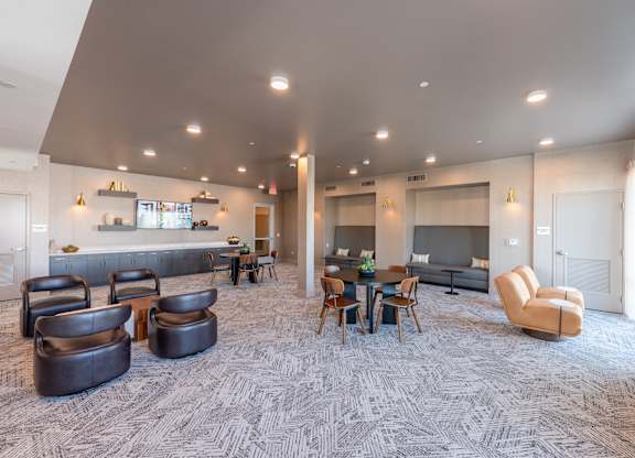 A spacious living room with a grey carpet and furniture.