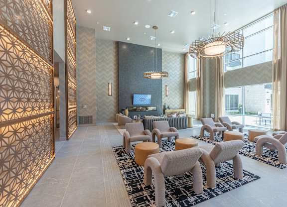 A modern living room with a patterned wall and a large window.