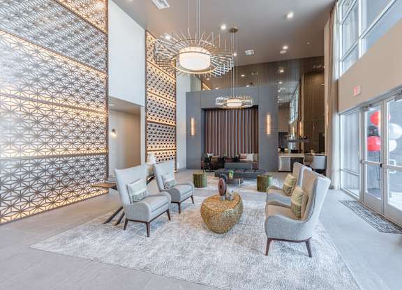 A modern living room with a patterned wall and a large window.