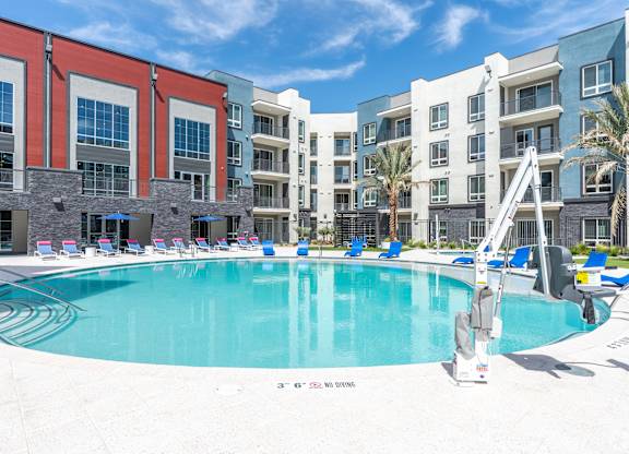 A pool in front of apartment buildings.