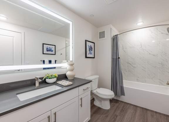 A bathroom with a toilet, sink, and bathtub.