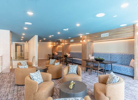 A spacious room with a blue carpet and furniture.
