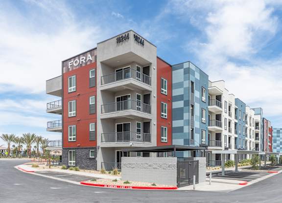 A multi-story apartment building with the name "FORA" on the top floor.