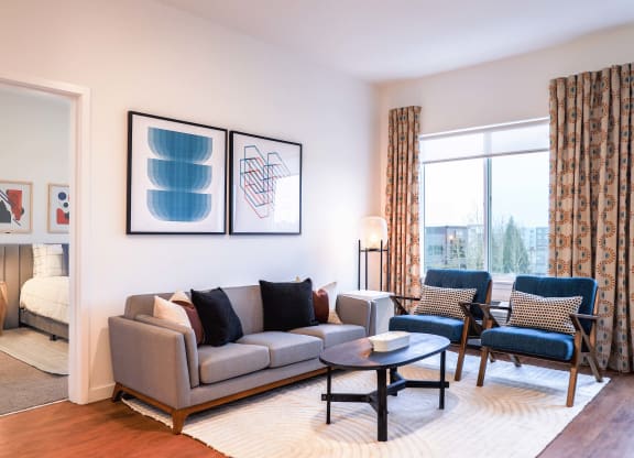 Two Bedroom Model Living Room Area with Window View at Hana Apartments, Hillsboro, Oregon