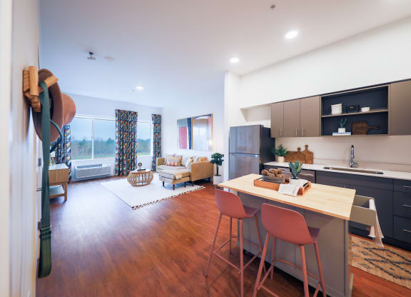 One Bedroom Model with Kitchen, Living Room and Wood Plank Flooring at Hana Apartments, Hillsboro