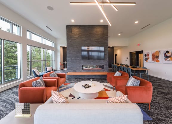 a living room with couches and a table and a television at Hana Apartments, Hillsboro, OR 97006