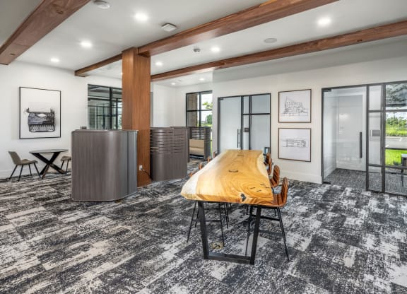 a conference room with a wooden conference table and glass doors at The Haven at Lake Britt Apartments, Winter Garden, FL 34787