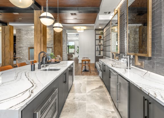 a large kitchen with two sinks and marble counter tops at The Haven at Lake Britt Apartments, Winter Garden, 34787