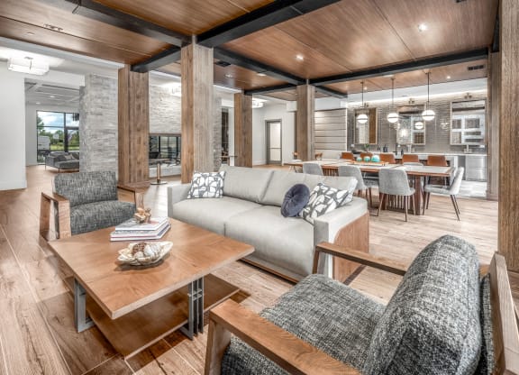 a living room and dining room with a couch and a table at The Haven at Lake Britt Apartments, Winter Garden, Florida