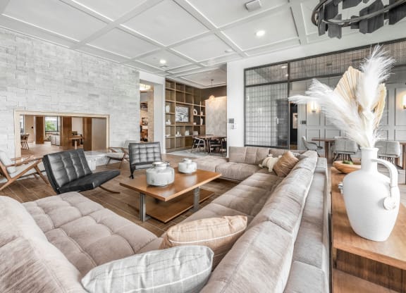 a living room with couches and chairs and a fireplace at The Haven at Lake Britt Apartments, Winter Garden, FL 34787