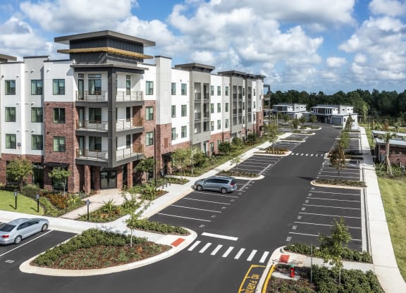 an aerial view of an apartment complex on a city street at The Haven at Lake Britt Apartments, Winter Garden