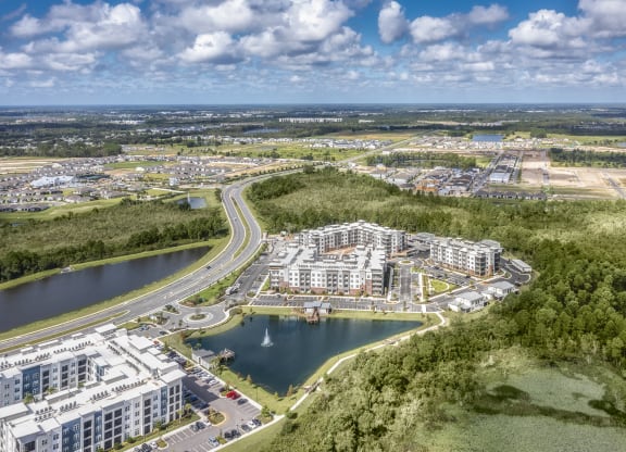 an aerial view of a city with a river and buildings at The Haven at Lake Britt Apartments, Winter Garden, Florida
