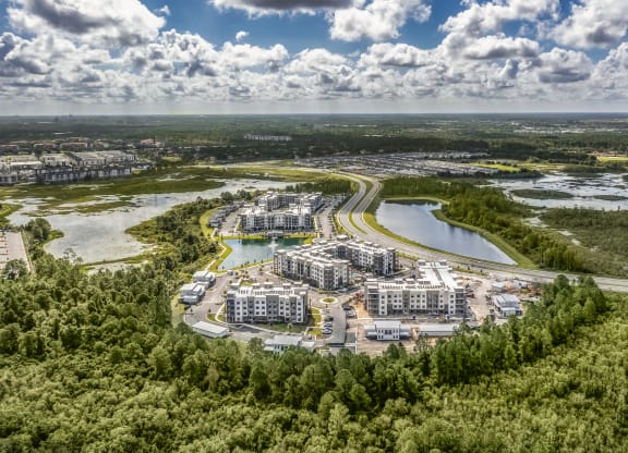 an aerial view of a city with a lake at The Haven at Lake Britt Apartments, Florida, 34787