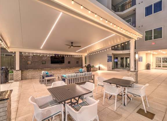 A patio with a table and chairs under a canopy.