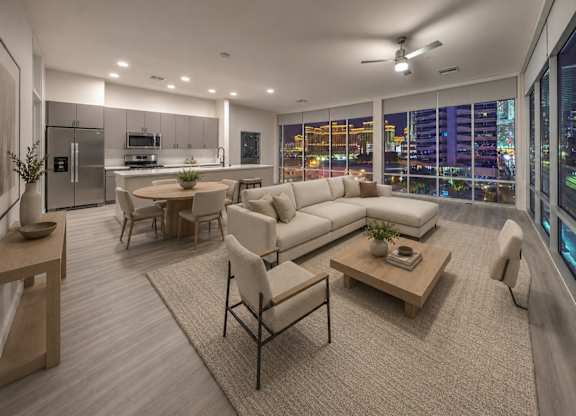 A modern living room with a view of the city at night.