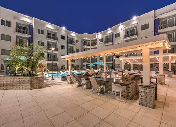 A large outdoor patio area with a bar and seating area.