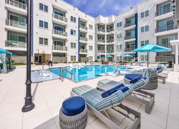 A sunny day at the poolside of a residential building.