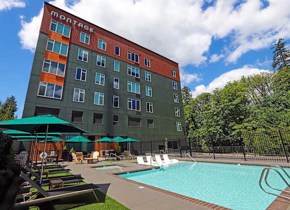 A Montage hotel with a pool and lounge chairs.