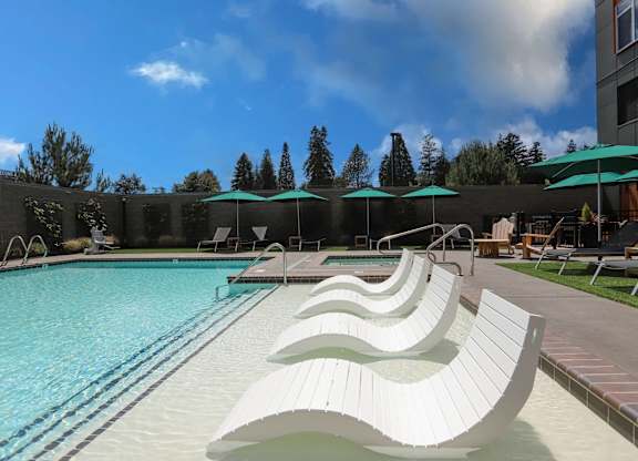 A swimming pool with a white, curved diving board.