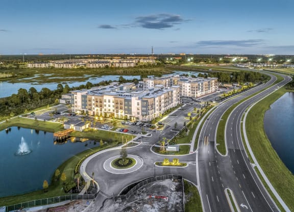 an aerial view of a large building next to a highway and a body of water at The Overlook, Winter Garden, FL