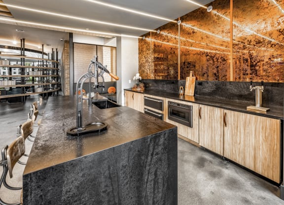 a kitchen with concrete countertops and wooden cabinets and a wine cellarat The Overlook, Winter Garden, FL, 34787