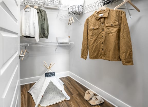 a walk in closet with a jacket hanging on the wall at The Overlook, Winter Garden, FL