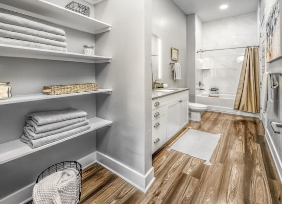 a renovated bathroom with a shower and shelves with towelsat The Overlook, Winter Garden, 34787