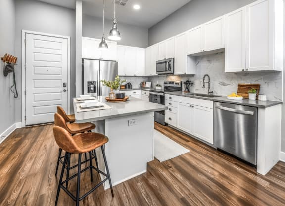 a kitchen with white cabinets and stainless steel appliancesat The Overlook, Florida