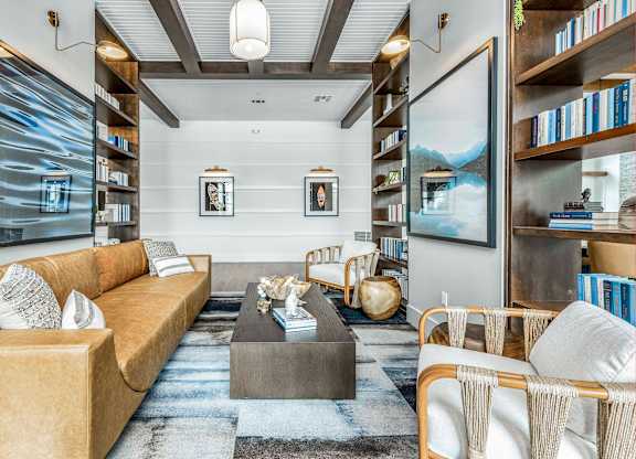 A living room with a sofa, armchairs, and a coffee table.