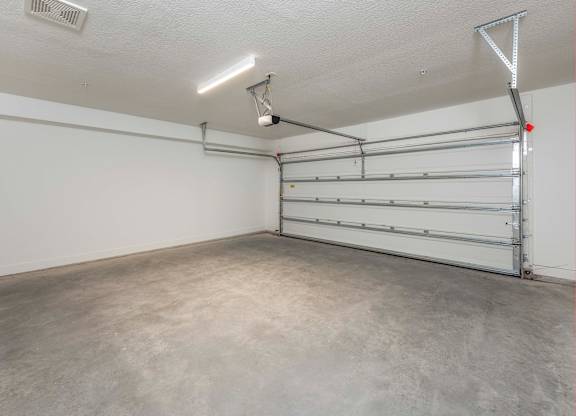 A garage with a white wall and a metal rack.