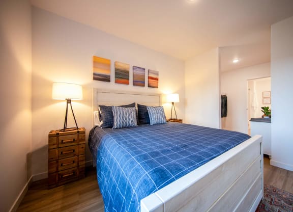 a bedroom with a bed and a blue blanketat Scouter's Mountain, Happy Valley, OR 97086