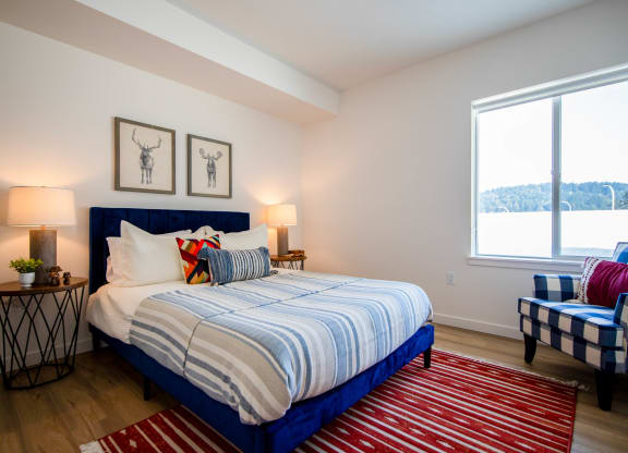 a bedroom with a bed and two chairsat Scouter's Mountain, Oregon, 97086