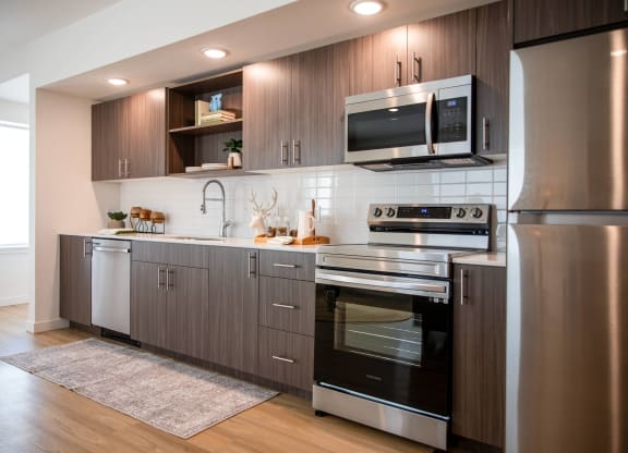 a kitchen with stainless steel appliances and wooden cabinetsat Scouter's Mountain, Happy Valley