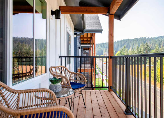 a balcony with chairs and a table at Scouter's Mountain, Oregon