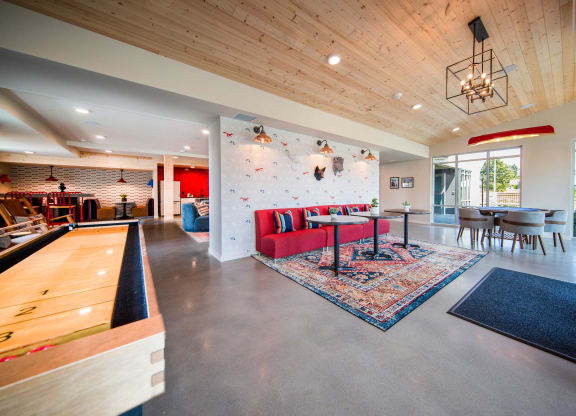 a large living room with a red couch and a dining room tableat Scouter's Mountain, Happy Valley, OR
