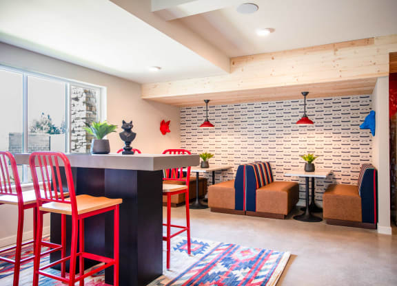 a kitchen and living room with red chairs and a white brick wall at Scouter's Mountain, Oregon, 97086