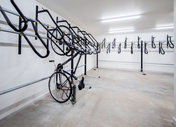 a row of bikes hanging from a wall in a white roomat Scouter's Mountain, Happy Valley