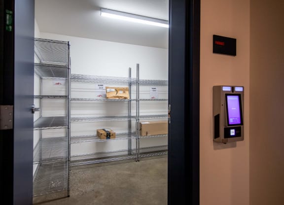 a door to a storage room with shelves and a monitor on the doorat Scouter's Mountain, Oregon, 97086