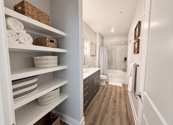 A bathroom with a white cabinet and a walk in shower.