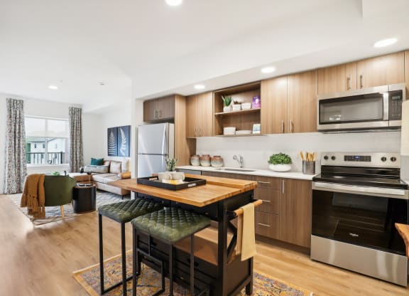 an open kitchen and living room with a table and chairs at The Mill on Maple Apartments, Oregon, 97045