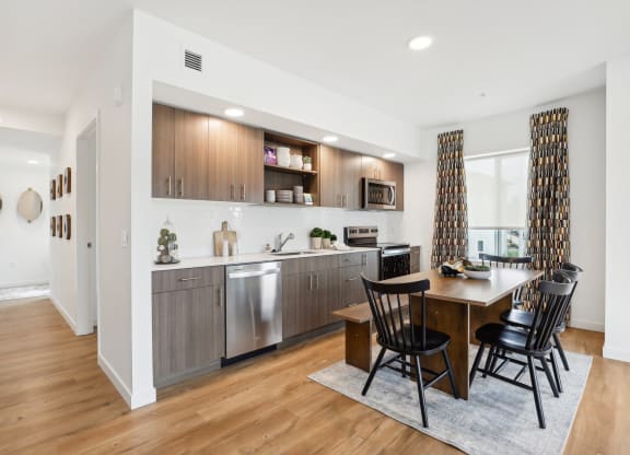 a kitchen and dining room with a table and chairs at The Mill on Maple Apartments, Oregon City, 97045