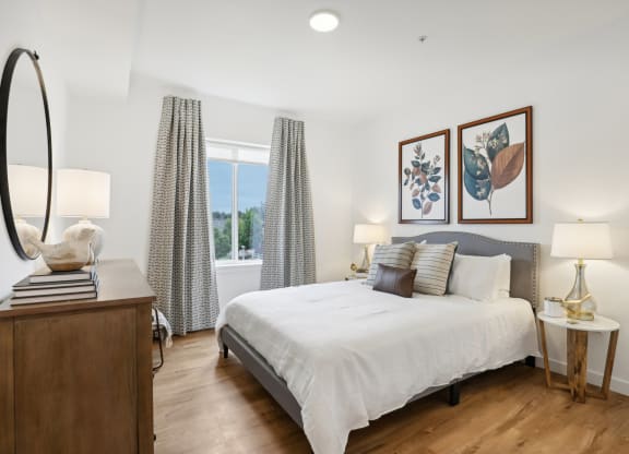 a bedroom with a bed and a dresser and a window at The Mill on Maple Apartments, Oregon City, 97045