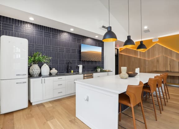 a kitchen with a large white island and a dining table at The Mill on Maple Apartments, Oregon City, OR