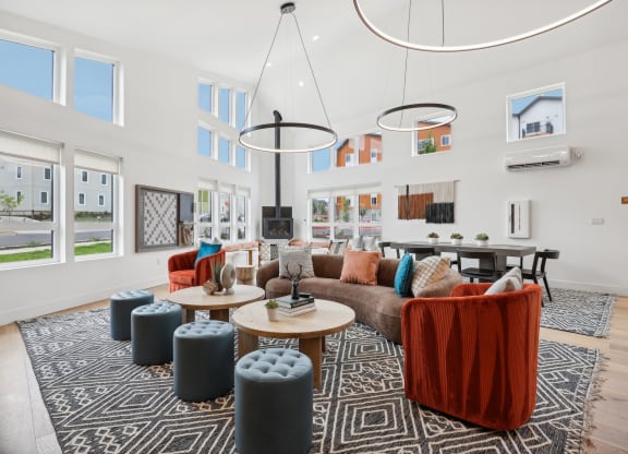 a living room with couches and chairs and a table at The Mill on Maple Apartments, Oregon City, OR 97045