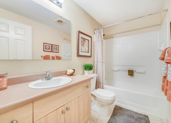 A bathroom with a white toilet, sink, and bathtub at The Lodge at Peasley Canyon, Washington 98001
