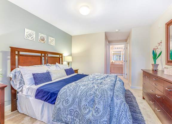 A bedroom with a bed, dresser, and mirror at The Lodge at Peasley Canyon in Federal Way, 98001