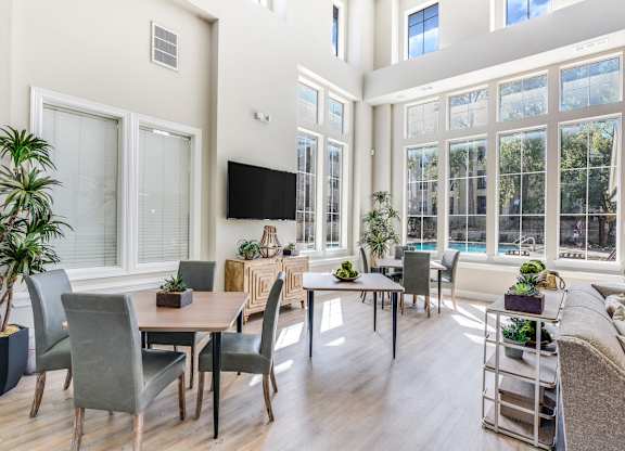 A well-lit room with a long table and chairs.