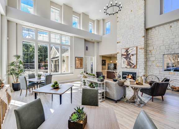 A modern living room with a fireplace and a large window.
